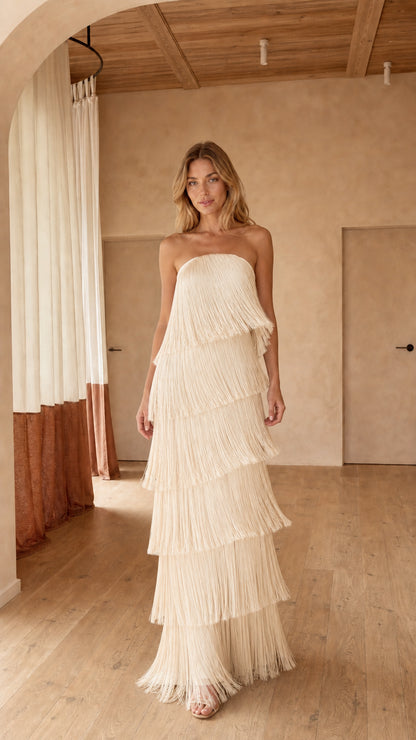 Front full-length view of strapless cream tiered fringe maxi dress