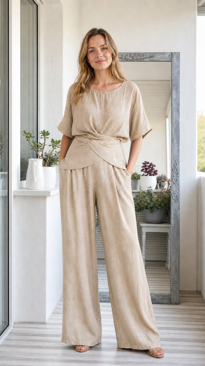 Model wearing beige oatmeal two-piece short sleeve twist top and wide leg pants set
