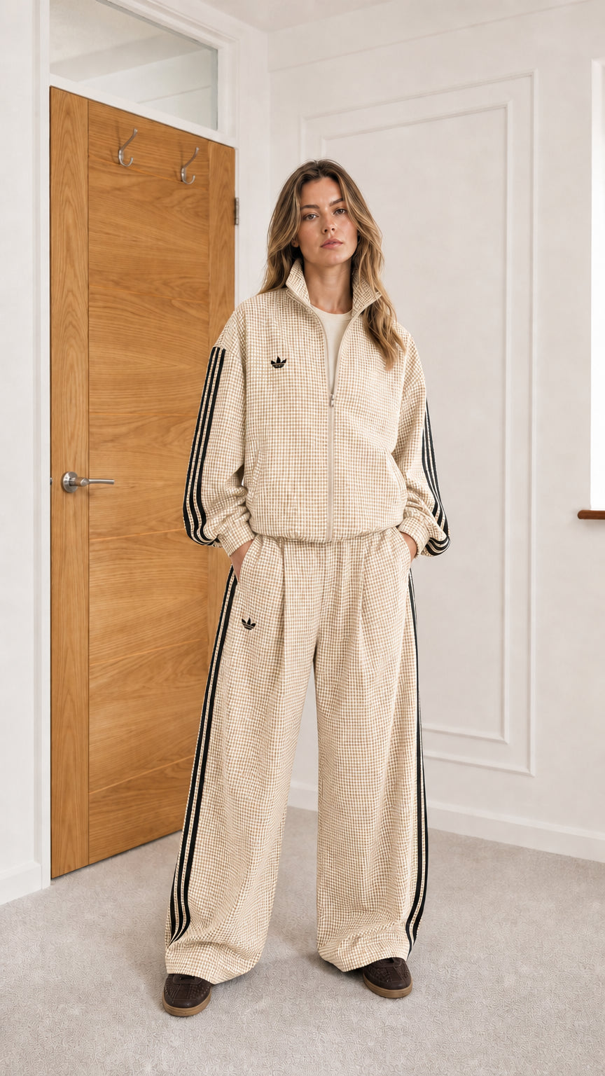 Model wearing cream houndstooth track jacket and matching wide-leg pants set