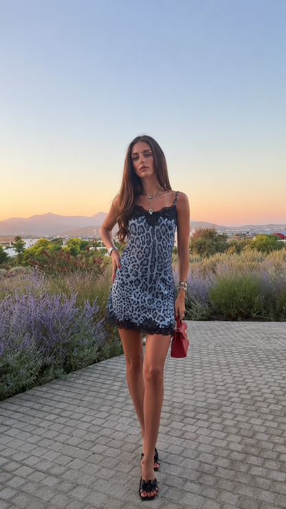 Woman wearing blue leopard print mini dress outdoors