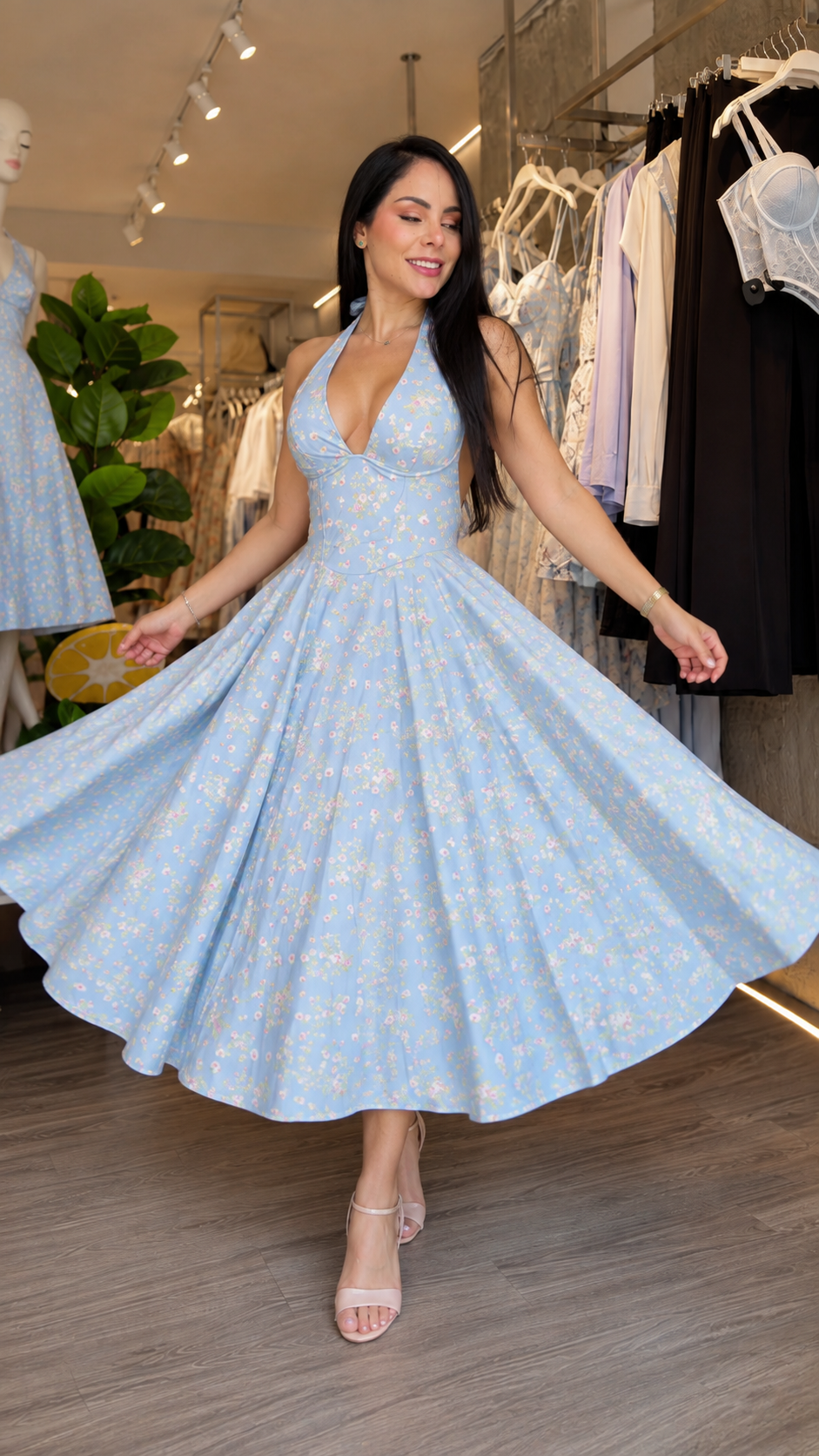 Woman wearing blue floral halter midi dress twirling